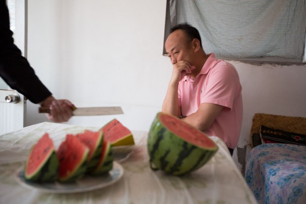 Lunch with Felix the fixer, and driver, with watermelon, in Daxing, near Beijing, China, Wednesday 30th May 2012.