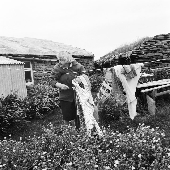 Jennie O' Scottigar, The oldest lady on the island when this was taken, bringing in her washing, 2008, North Ronaldsay. Jennie O' Scottigar, The oldest lady on the island when this was taken, bringing in her washing, 2008, North Ronaldsay.
