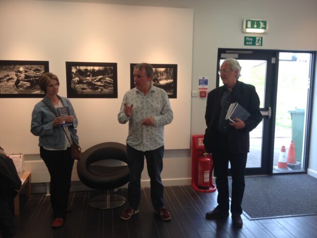 Malcolm Dickson (centre) of Street Level Photoworks introduces the show.